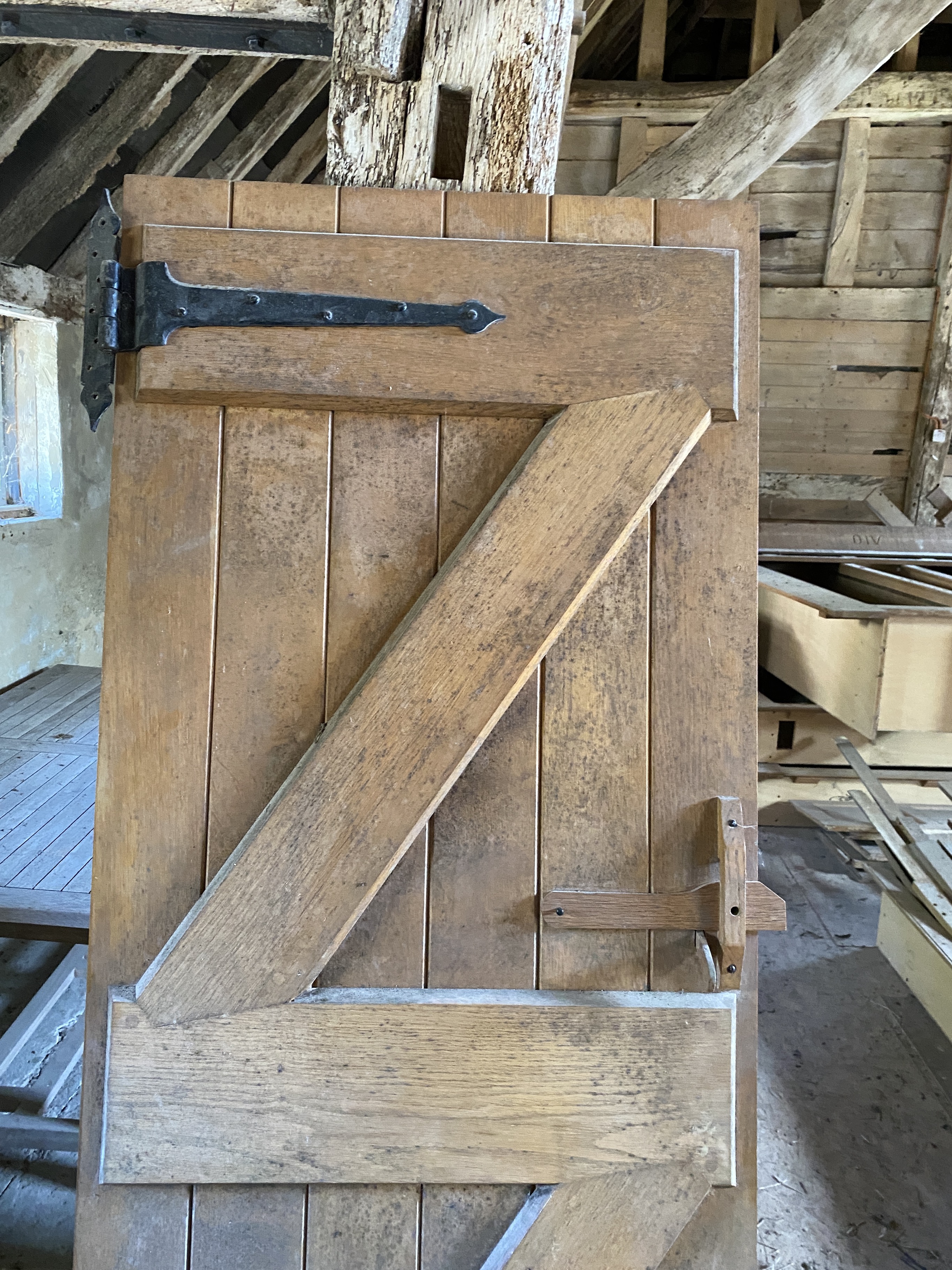 Three solid oak ledged and braced doors, 210 x 58.5cm; 204 x 44.5cm and 95 x 72cm, and a double sided panelled solid oak door, 200 x 64cm (4)